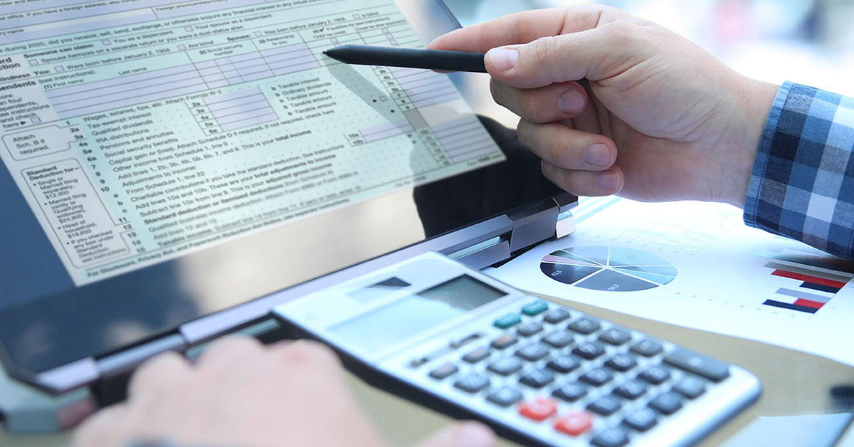 Tax Accountant looking at computer with tax form